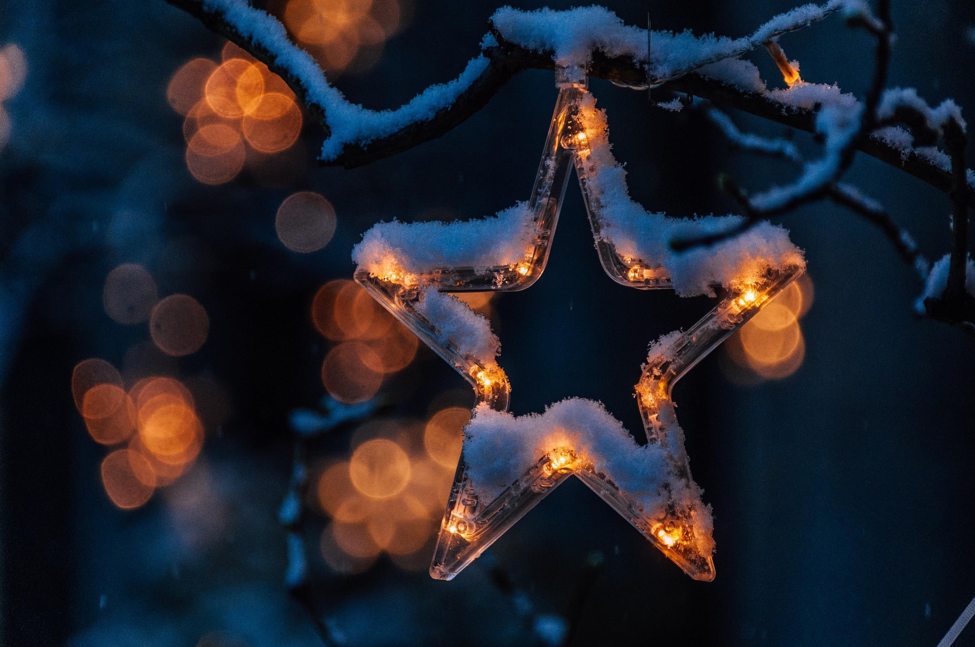 Holiday lights in shape of a star covered in snow