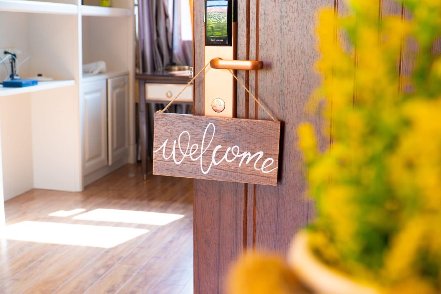 Welcome sign hanging on door knob