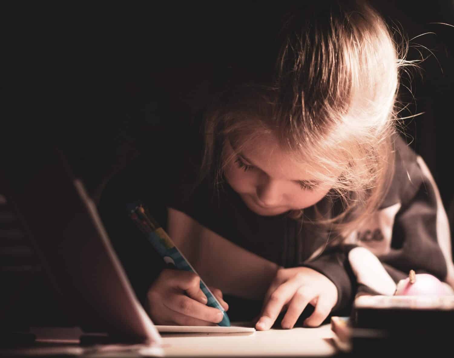Young girl writing in notebook
