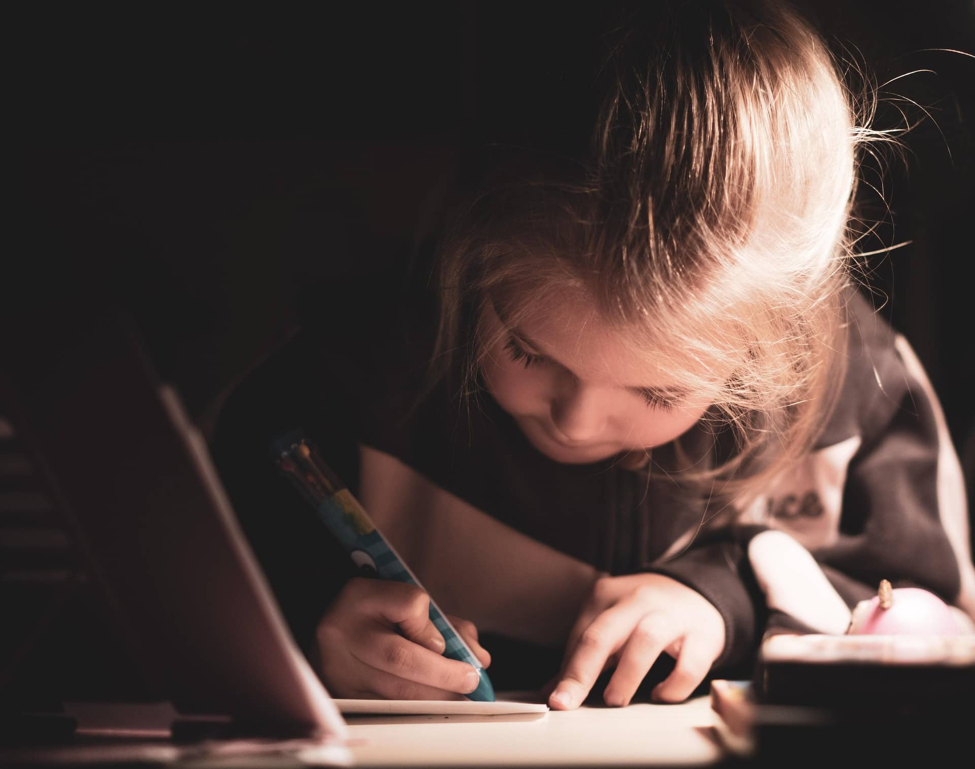 Young girl writing in notebook