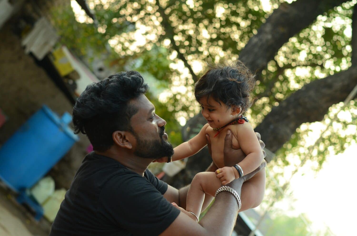 Father holding up young son
