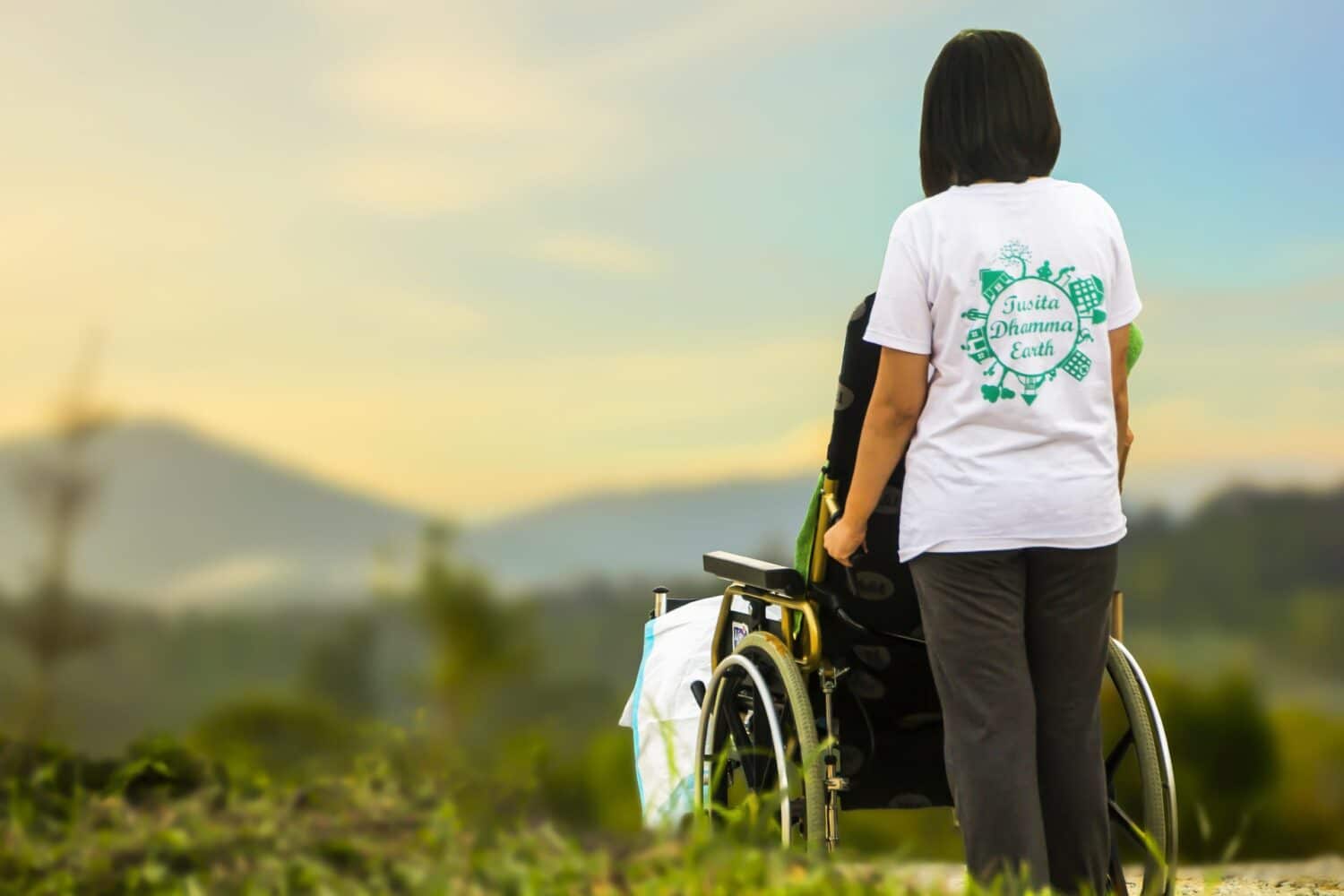 Back of woman pushing wheelchair