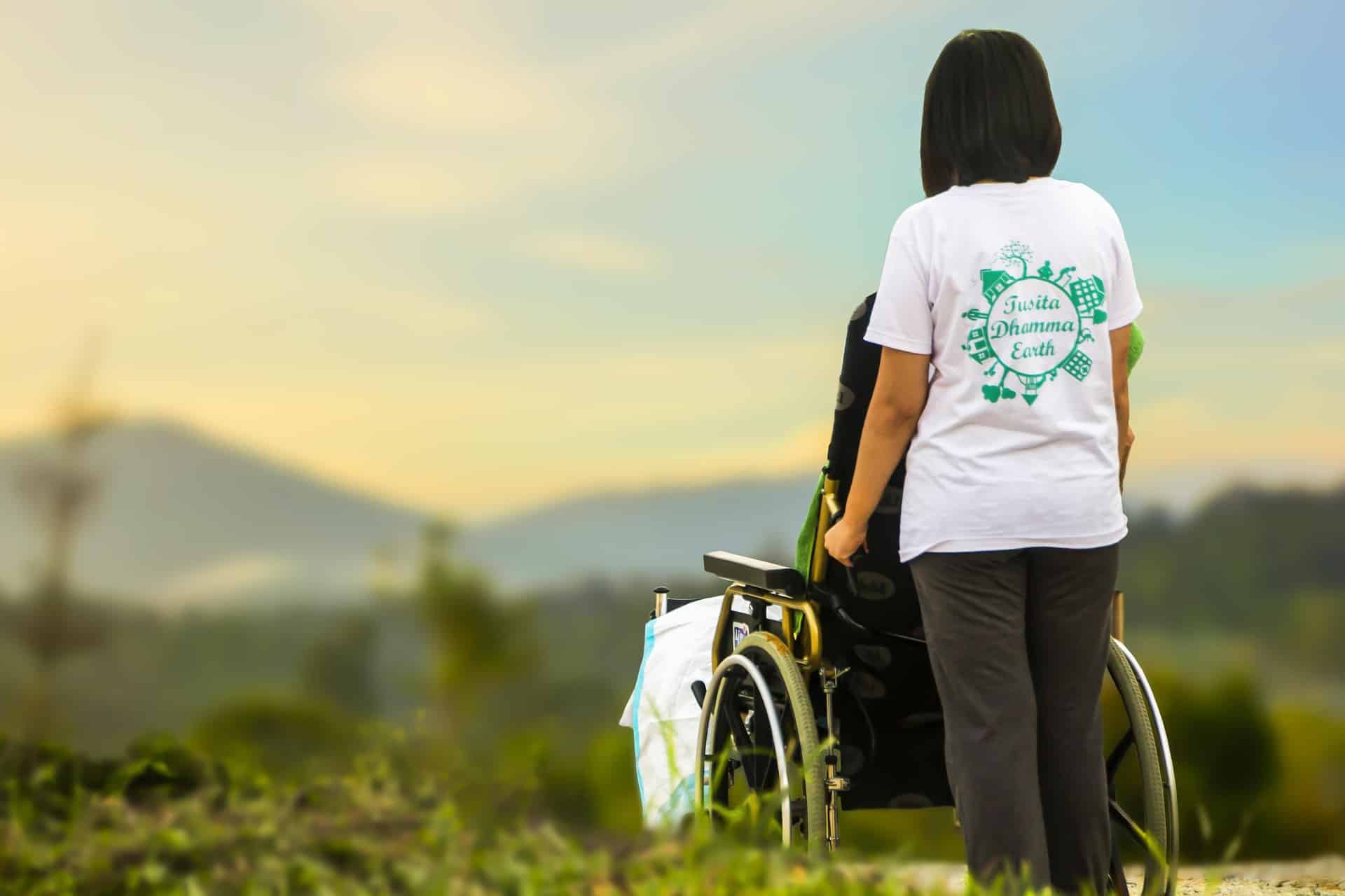 Back of woman pushing wheelchair
