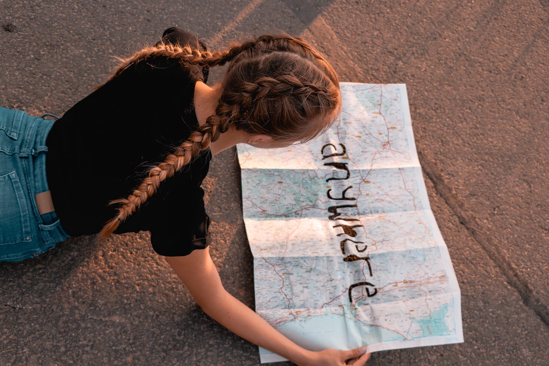 Girl reading a map to anywhere