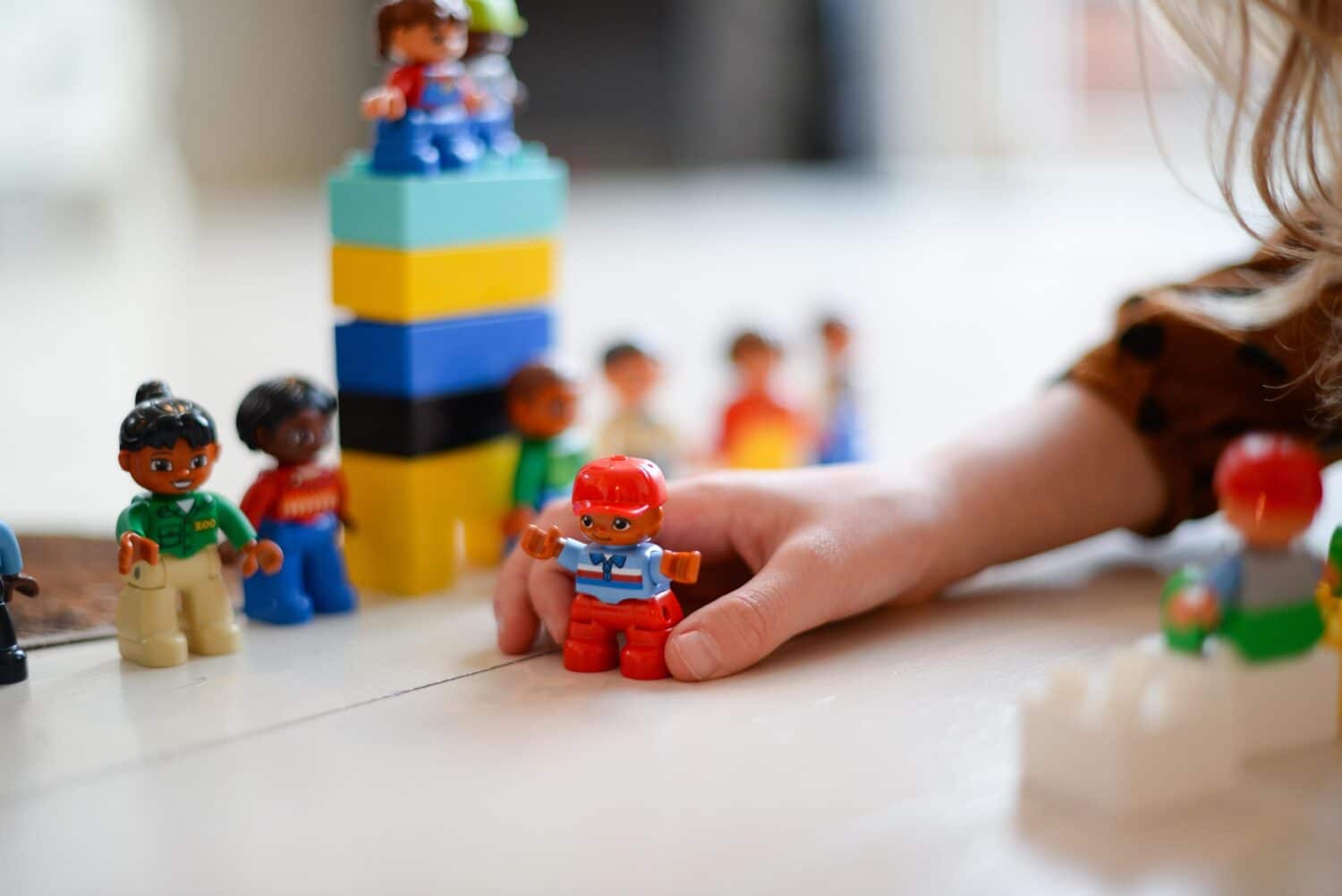 kid's hand playing with toys and blocks