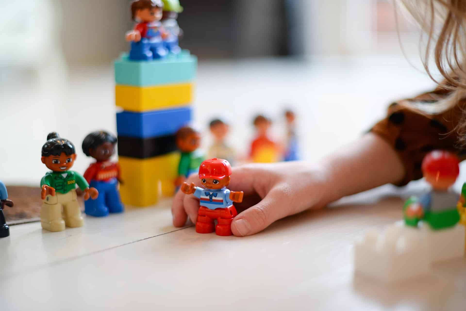 kid's hand playing with toys and blocks
