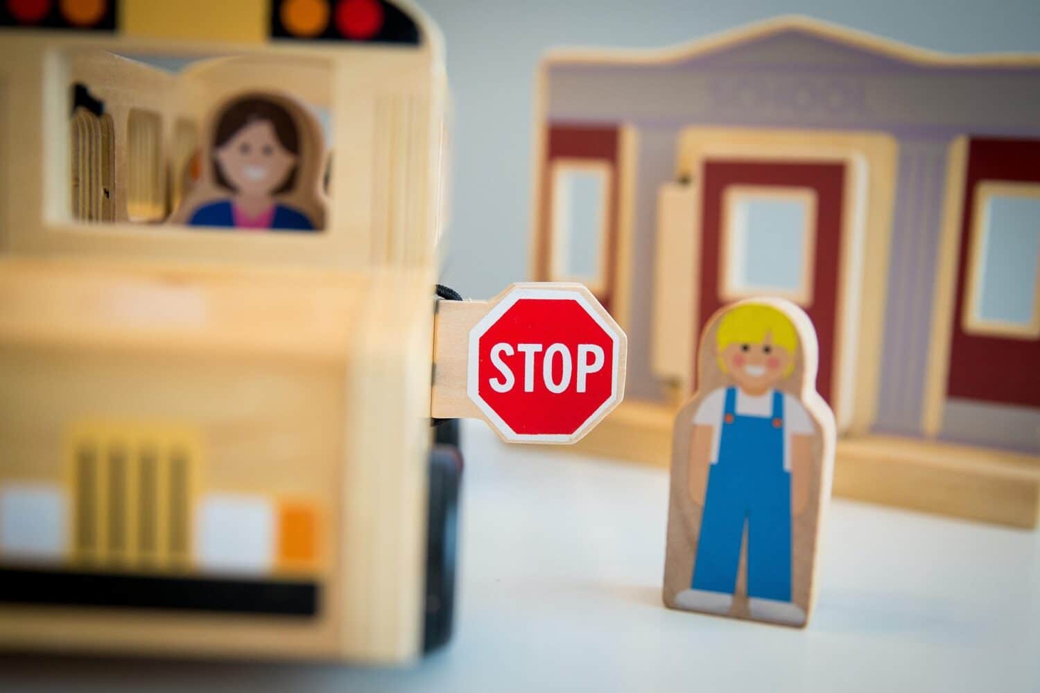 Toy school bus with driver and child
