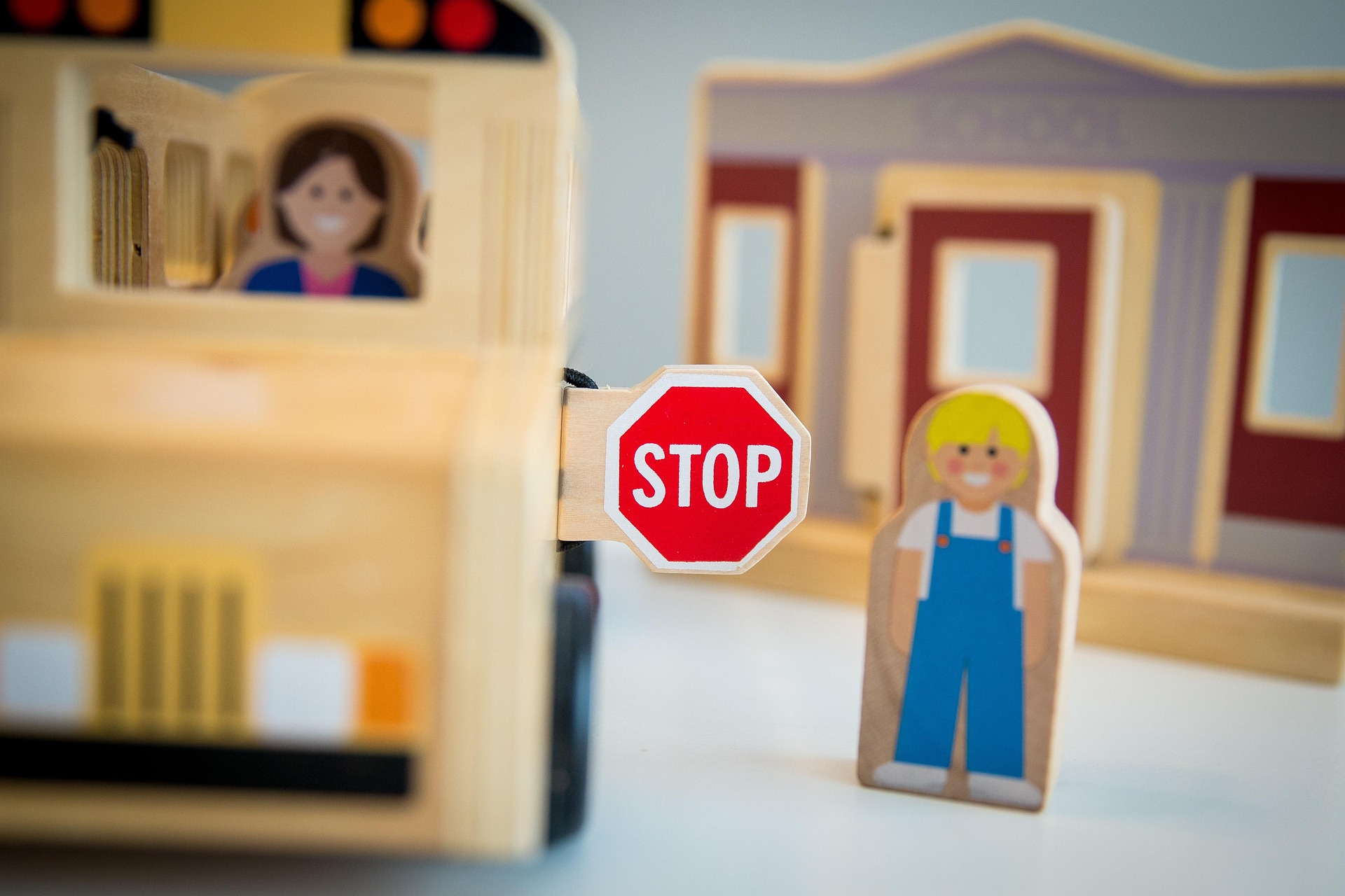 Toy school bus with driver and child