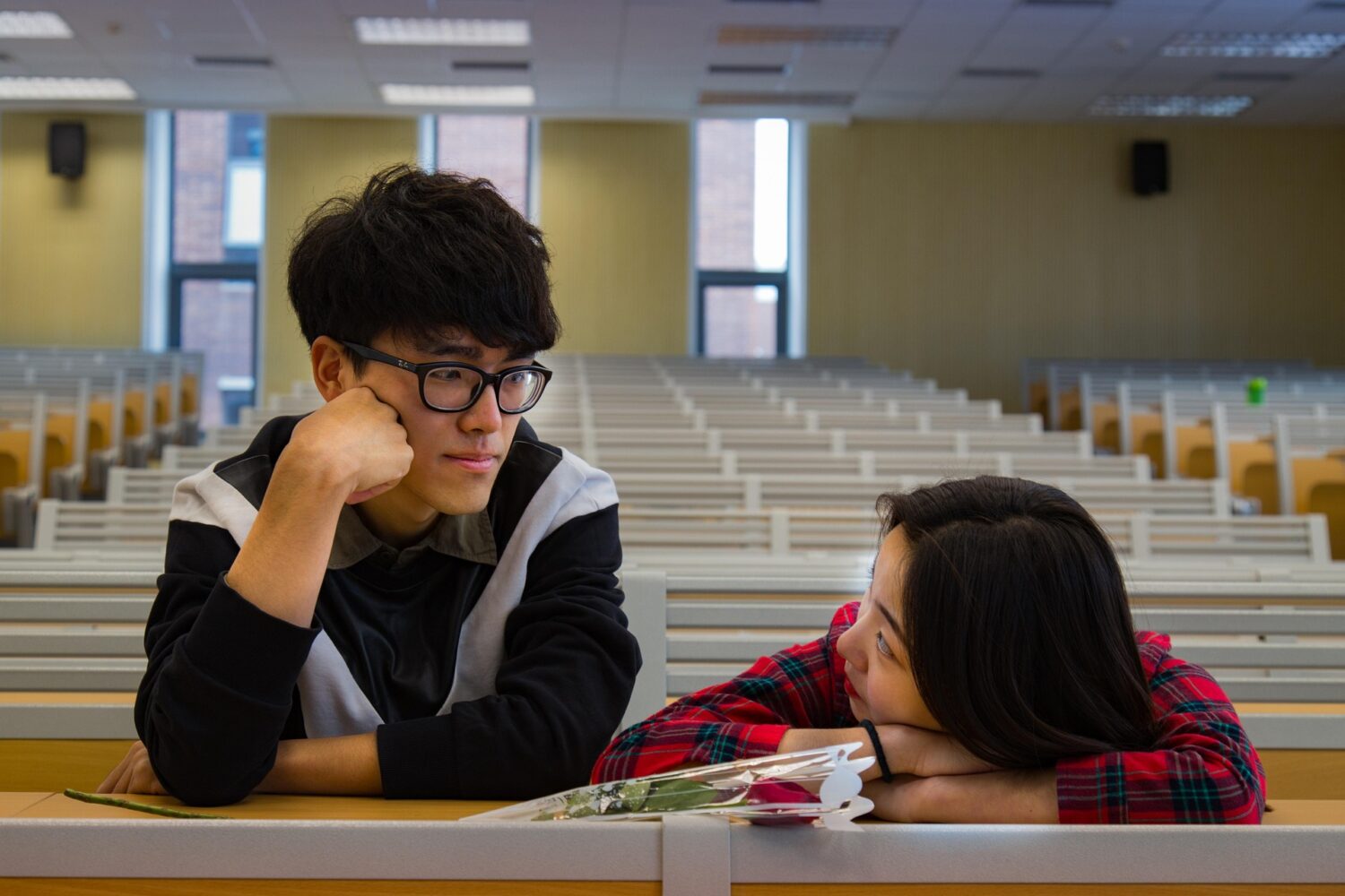 Two teenagers in an empty classroom