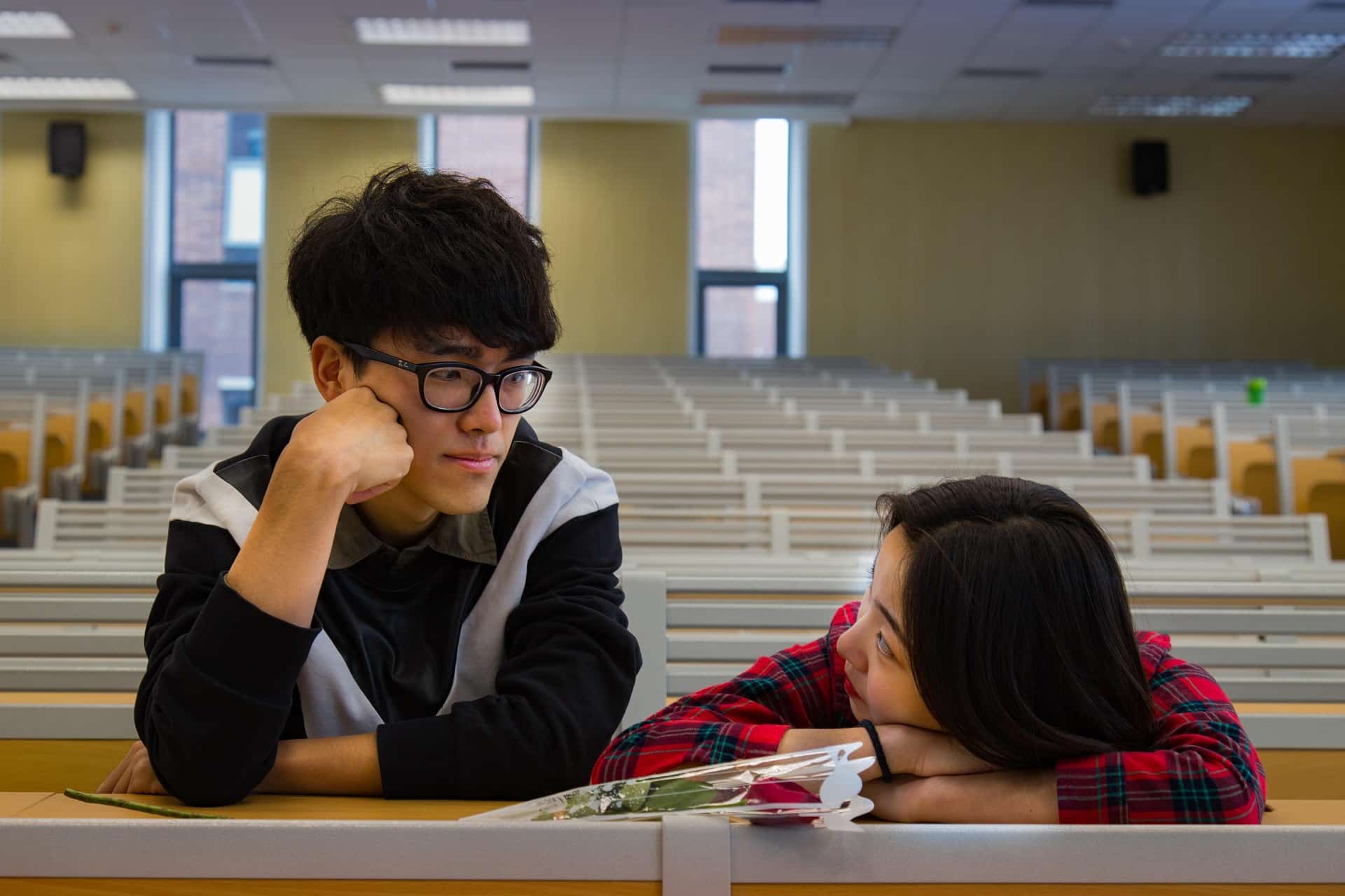 Two teenagers in an empty classroom