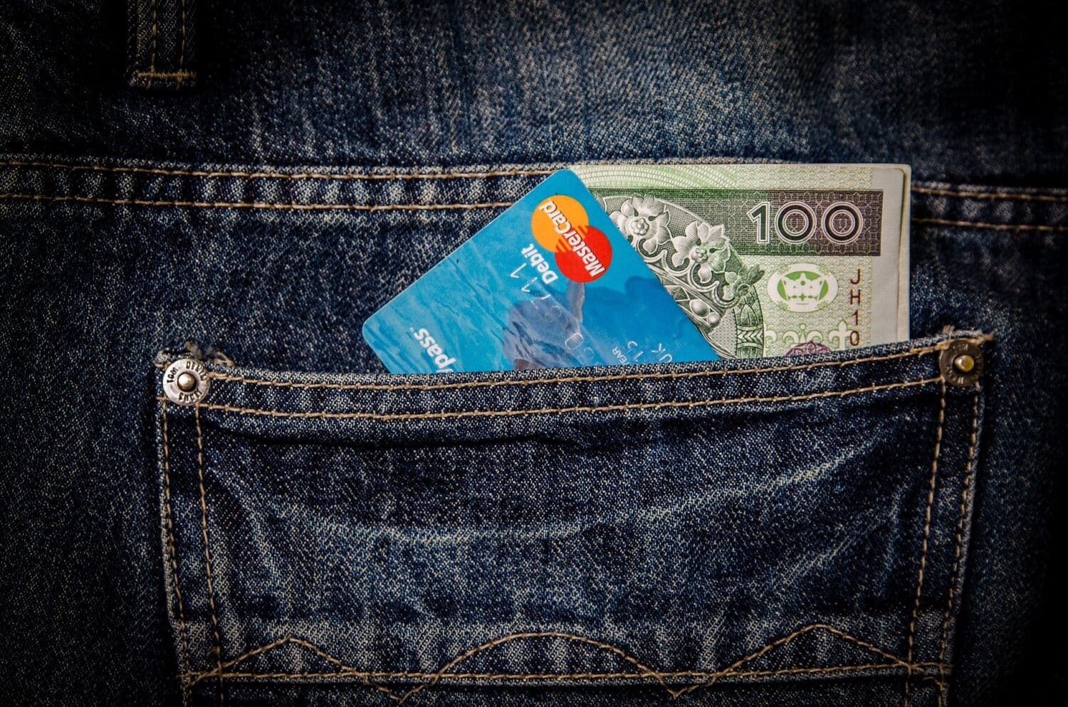 Money and credit card in jeans pocket